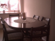 Oval dark wood dining table and chairs